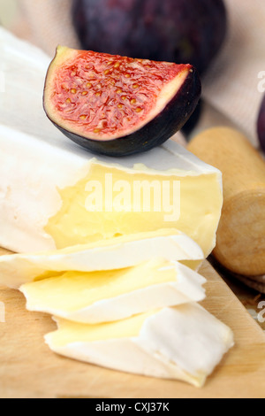 cheese and sweet fruit  figs on a wooden board Stock Photo