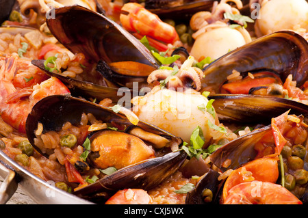 Seafood Paella with mussels, shrimps and calmari as closeup in a pan Stock Photo