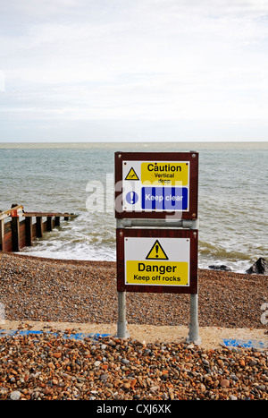 Warning signs relating to Health and Safety on the seawall at Slaughden, near Aldeburgh, Suffolk, England, United Kingdom. Stock Photo