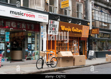 Shops selling musical instruments and offering lessons in Denmark Street in the West End of Central London. Stock Photo