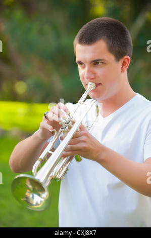 Young boy practicing playing trumpet in living room at home Stock Photo -  Alamy