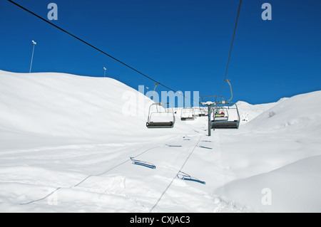 Ski lift chairs on bright winter day Stock Photo