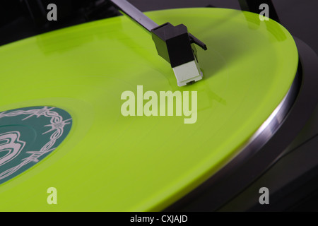 Colored vinyl record playing on turn table Stock Photo