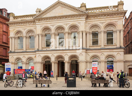 Busy street scene by Tesco Metro store in an old building with shoppers outside in city centre of Belfast Northern Ireland UK Stock Photo