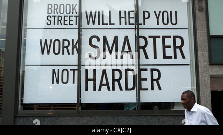 Employment Bureau Brook Street Will Help You Work Smarter Not Harder poster and signs in London England UK Stock Photo