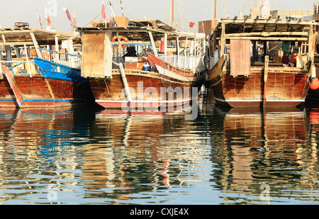 Old dhows of Qatar's fishing fleet moored in the Dhow Harbour off Doha Corniche Stock Photo