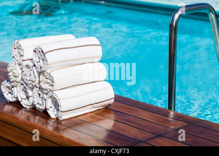 Prepared towels next to empty Swimming Pool. Cunard Liner Queen Victoria. Stock Photo
