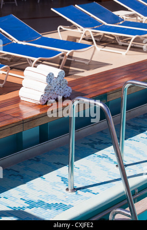 Prepared towels next to Swimming Pool. Cunard Liner Queen Victoria. Stock Photo