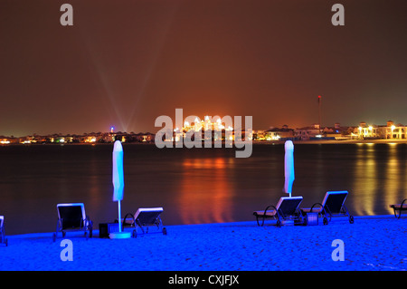Beach of luxury hotel in night illumination on Palm Jumeirah man-made island, Dubai, UAE Stock Photo