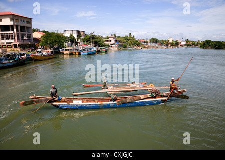 Traditional catamaran used by fishermen in Sri Lanka sailing in the Negombo lagoon Stock Photo