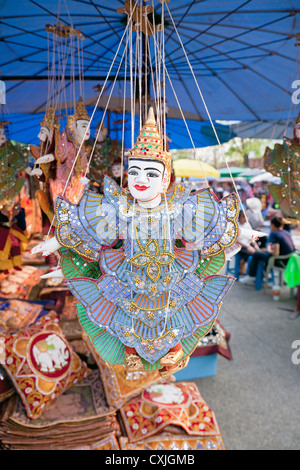 Street market stall with traditional puppet gift, near Tha Phae Gate, Chiang Mai, Thailand Stock Photo