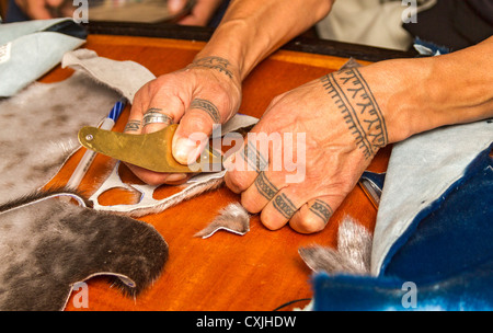 Inuit woman demonstrates seal skin cutting and sewing techniques. Stock Photo