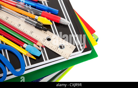 Stack of notebooks with school supplies on a white background Stock Photo