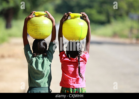 Young Indian girls carrying water pots Andhra Pradesh South India Stock Photo