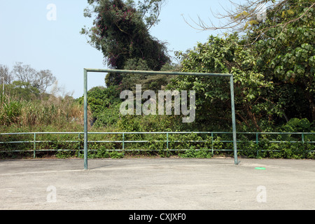 It's a photo of the goal of a street football playground near a village. There is a forest behind and nobody in the frame. Sport Stock Photo