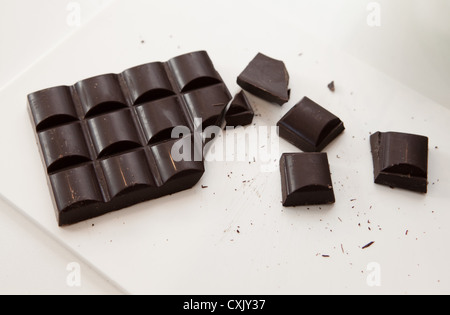 block of dark chocolate cut into pieces Stock Photo