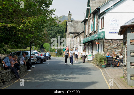 People visitors tourists walking in Grasmere village in summer Cumbria Lake District National Park England UK United Kingdom GB Great Britain Stock Photo