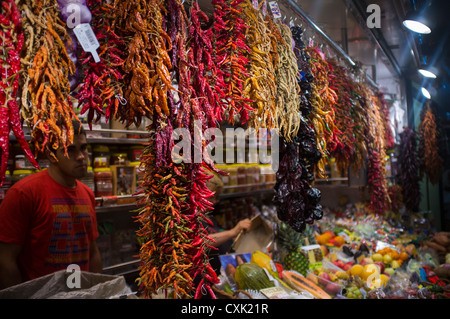 Dried chillies hang from a stall in Barcelona's La Boqueria market. Stock Photo