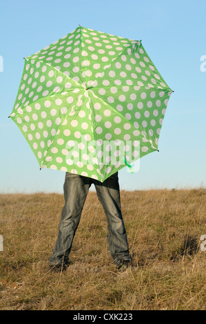 Boy with Umbrella in Field, Rogues, France Stock Photo