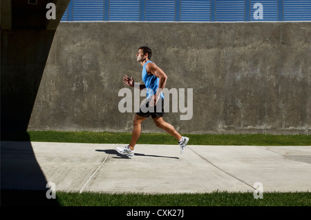 Man Running on Sidewalk Stock Photo