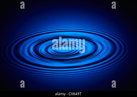 Droplet of Water on Blue Causing Ripples Stock Photo