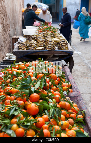 Man selling fruit from carts in the street, Essaouira, Morocco Stock Photo
