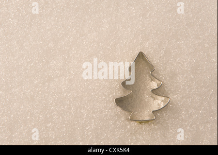 Tree-Shaped Cookie Cutter in Snow Stock Photo
