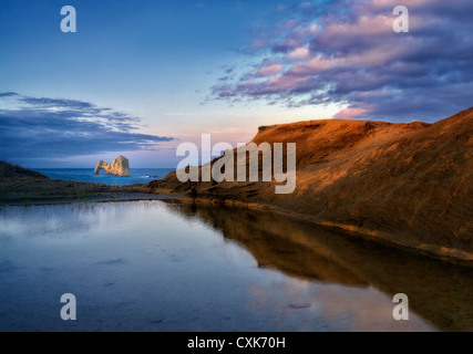 Mack Arch at sunrise and reflecting pool of water. Oregon Stock Photo