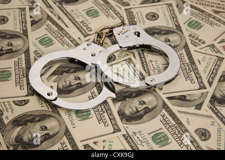 Dollar bills and handcuffs Stock Photo
