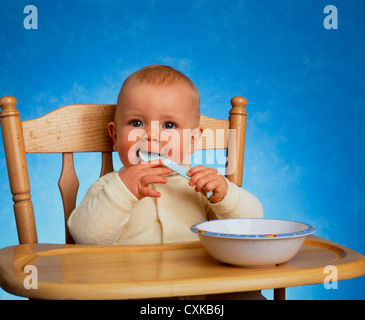 BABY SITTING IN HIGHCHAIR Stock Photo