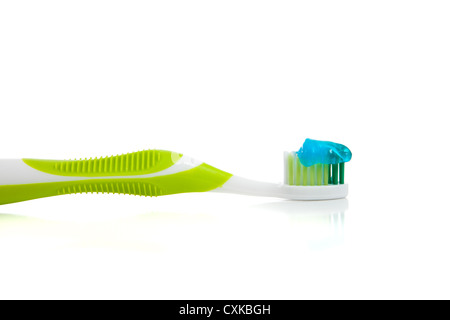 White toothbrush with green gel toothpaste isolated on white background ...