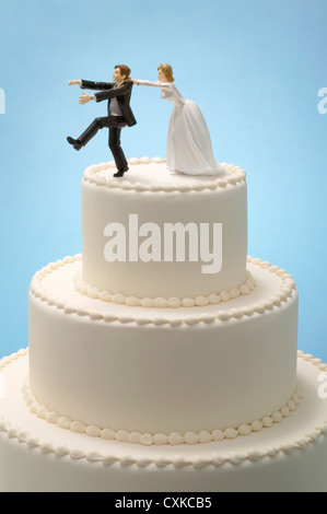 bride and groom cake topper with runaway groom 2 Stock Photo