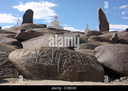 Carved prayer stones looking towards Shey Monastery to the south of Leh in Ladakh Northern India