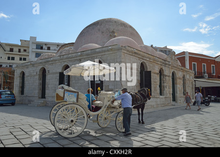 Horse carriage and Kioutsouk Hasan Mosque on seafront promenade, Chania, Chania Region, Crete, Crete Region, Greece Stock Photo