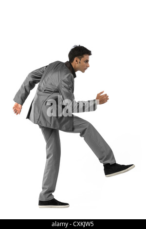 Indian business man climbing. Isolated on white background Stock Photo
