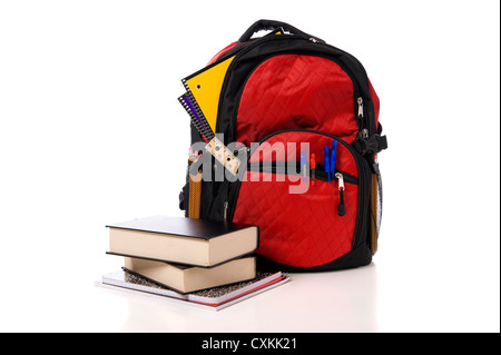 A red overflowing school backpack or book bag with school books on a white background Stock Photo