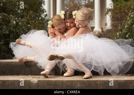 girls hugging in ballet costumes Stock Photo