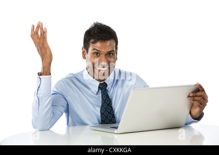 Portrait of a really happy Indian business man working with his laptop. Stock Photo