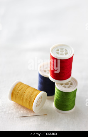 Spools of Thread and Sewing Needle Stock Photo