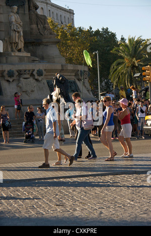 tourist guide with group of tourists carrying a flag in las ramblas street also known as la rambla,barcelona,spain,europe Stock Photo