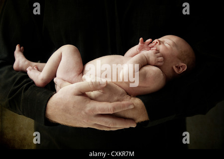 Father Holding Newborn Son Stock Photo