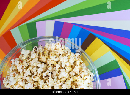 Popcorn in a bowl on colour background Stock Photo