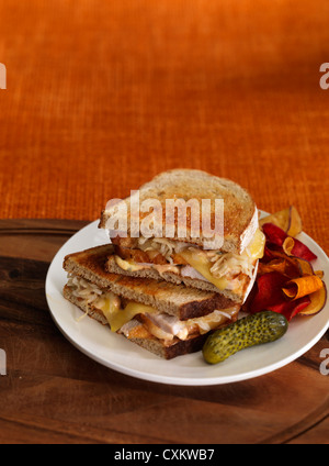 Turkey Reuben Sandwich with Pickle and Vegetable Chips Stock Photo