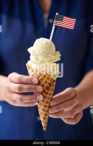 Woman Holding Vanilla Ice Cream Cone with American Flag Stock Photo