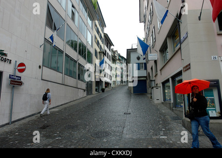 Walking on a narrow cobblestone street in Zurich. The streets were deserted since it was a holiday and had just rained. Stock Photo