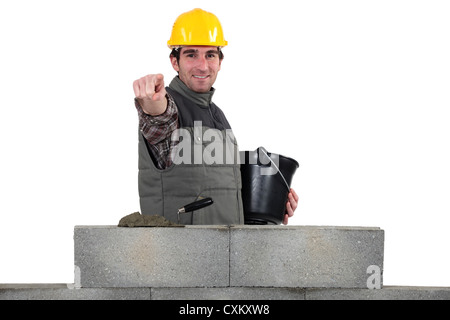Bricklayer pointing ahead Stock Photo
