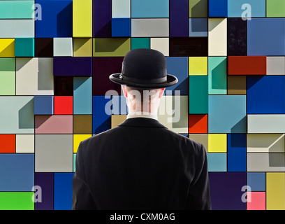 man facing multi-colored wall Stock Photo