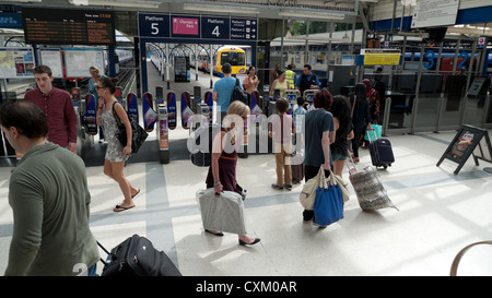 Underground passengers carrying luggage and bags amongst travellers in train station hall at Richmond upon Thames, London, England UK   KATHY DEWITT Stock Photo