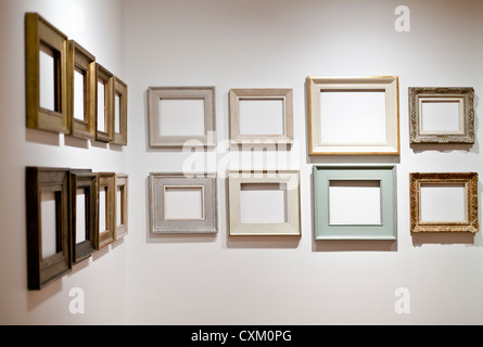 empty picture frames arranged on a white wall Stock Photo