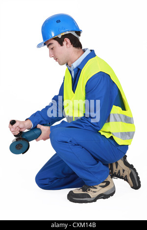 Contractor using angle grinder Stock Photo
